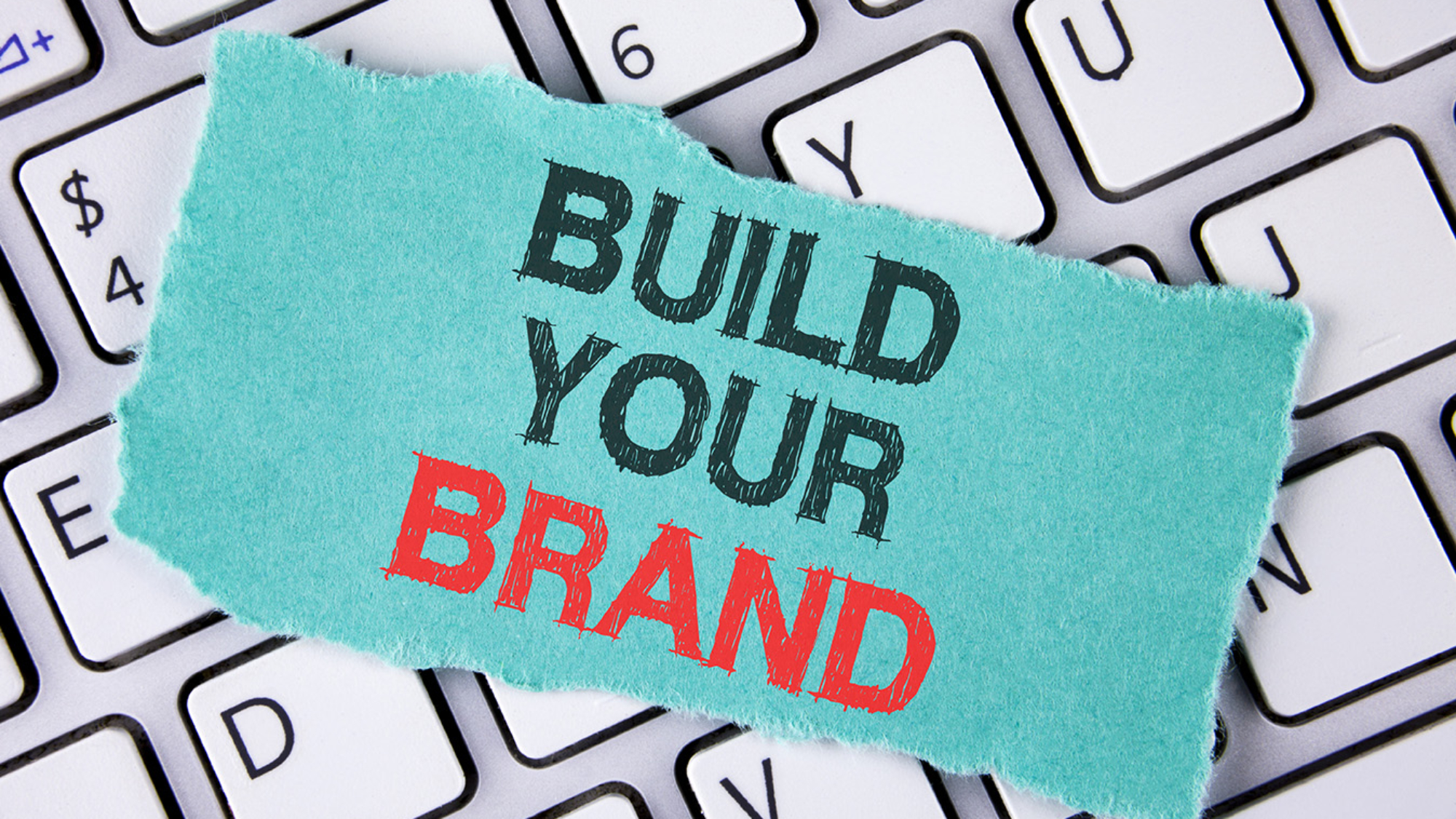 Handwriting text writing Build Your Brand. Concept meaning create your own logo slogan Model Advertising E Marketing written tear Sticky Note Paper placed the Laptop.